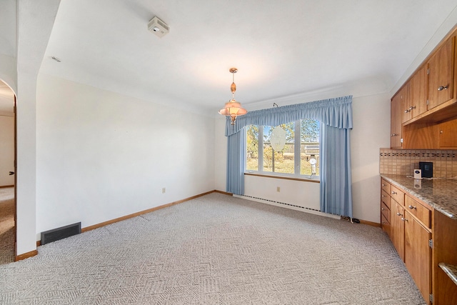 unfurnished dining area with light colored carpet