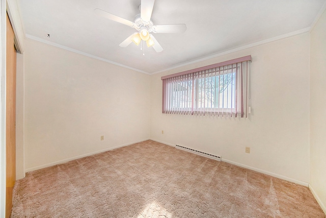 carpeted empty room featuring crown molding, ceiling fan, and a baseboard heating unit