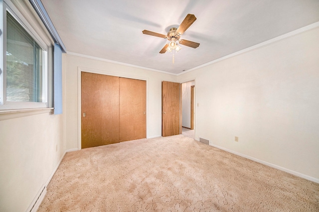 unfurnished bedroom featuring light carpet, ceiling fan, and crown molding