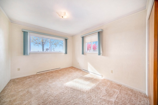 unfurnished room with light carpet, crown molding, and a baseboard heating unit