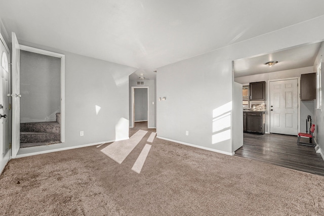 unfurnished living room with dark wood-type flooring