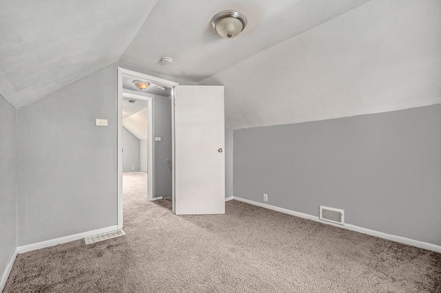 bonus room featuring light colored carpet and lofted ceiling