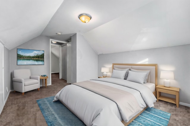 bedroom featuring dark colored carpet and lofted ceiling