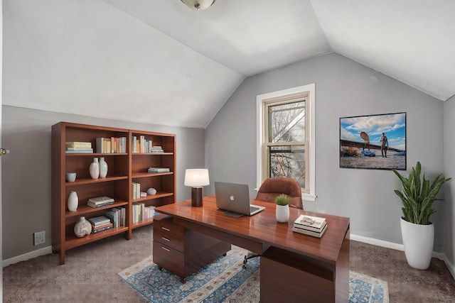 carpeted office space featuring vaulted ceiling