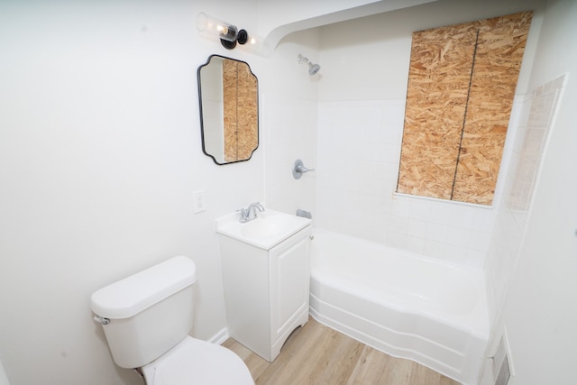 full bathroom with hardwood / wood-style floors, vanity, toilet, and tiled shower / bath