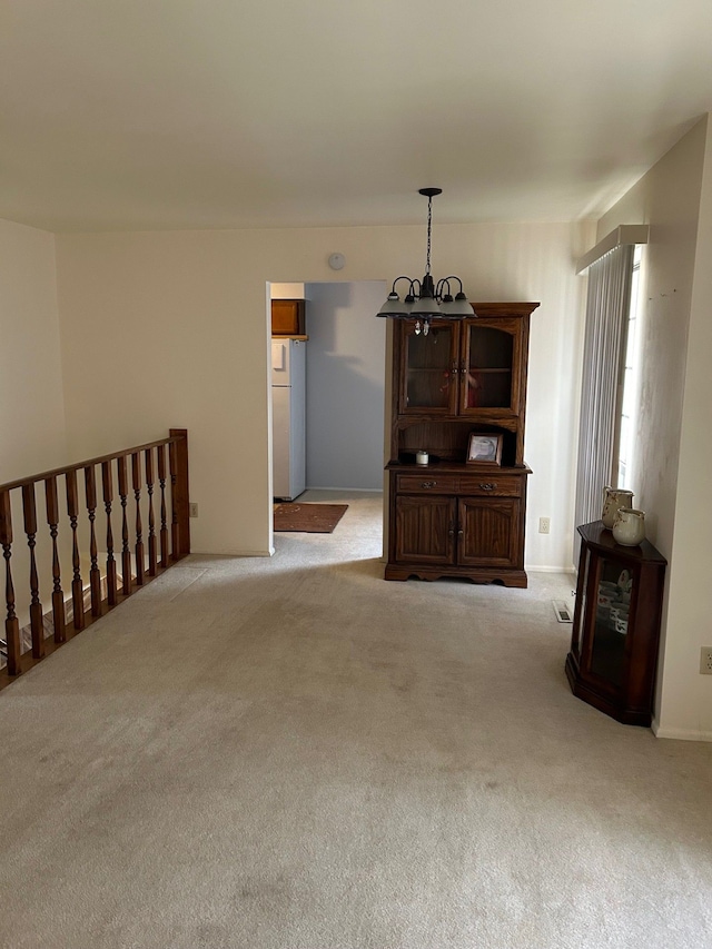 2369 E Golden Shores Dr, Fenton, MI 48430 - living room with light carpet and a chandelier