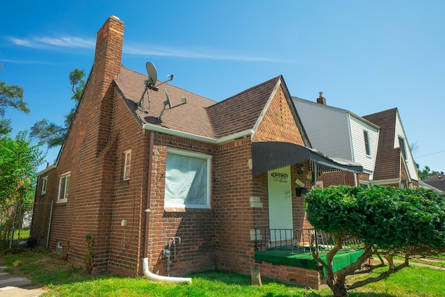 16226 Mark Twain St, Detroit, MI 48235 - view of front of home with brick siding, a chimney, and roof with shingles