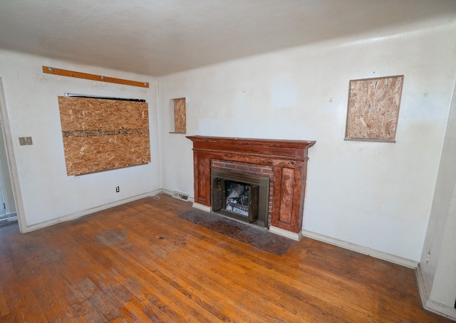 unfurnished living room with hardwood / wood-style flooring