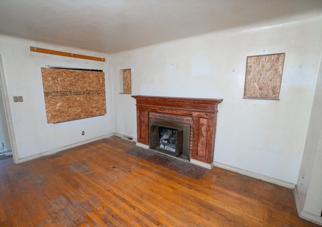 16226 Mark Twain St, Detroit, MI 48235 - unfurnished living room with wood finished floors, a fireplace with flush hearth, and baseboards