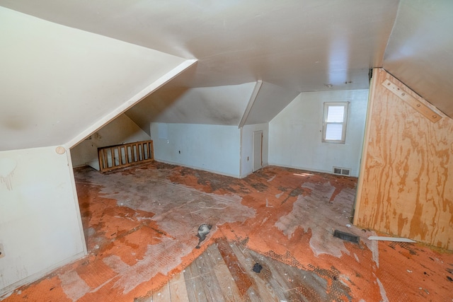 additional living space featuring lofted ceiling