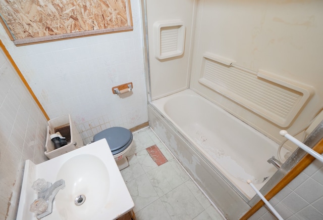 full bathroom with vanity, shower / washtub combination, toilet, and tile walls