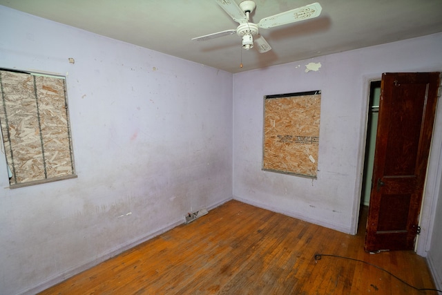 empty room with ceiling fan and wood-type flooring