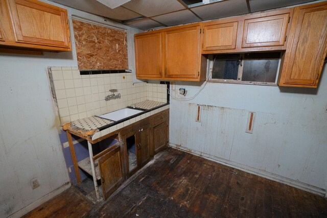 16226 Mark Twain St, Detroit, MI 48235 - kitchen featuring tile countertops, dark wood finished floors, baseboards, a sink, and backsplash