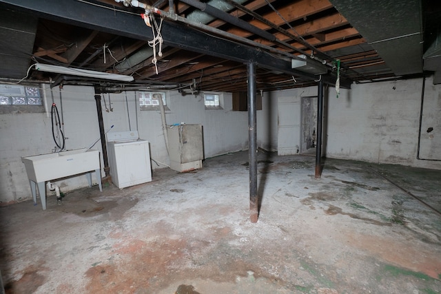 basement featuring washer / dryer and sink