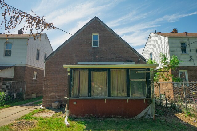 16226 Mark Twain St, Detroit, MI 48235 - back of property with a sunroom and brick siding