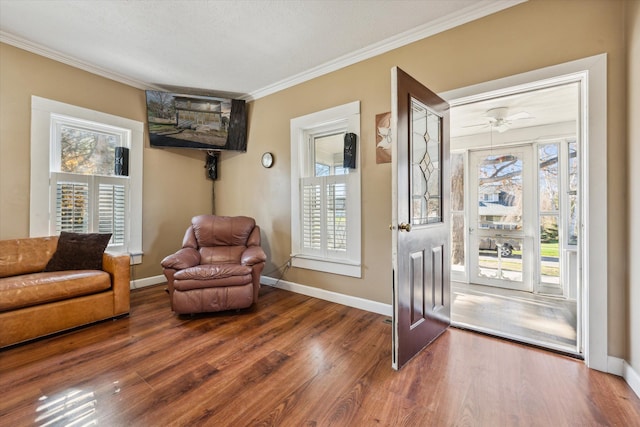 living area featuring a textured ceiling, dark hardwood / wood-style floors, ceiling fan, and crown molding