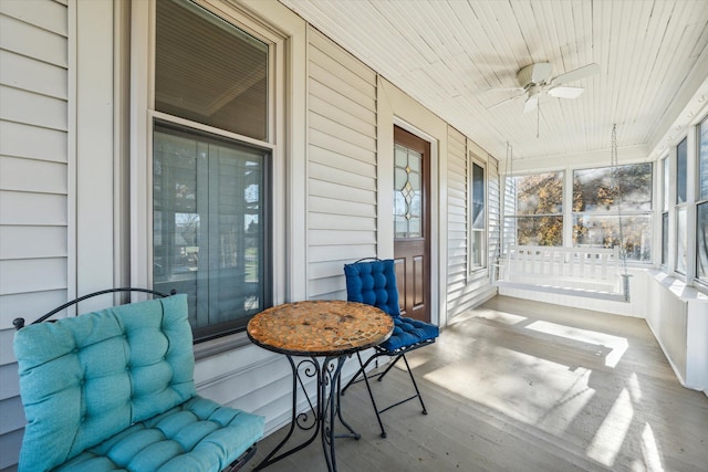 sunroom featuring ceiling fan and wooden ceiling