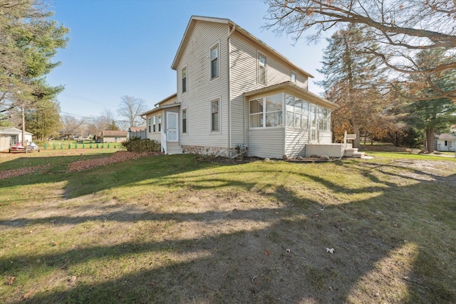 view of side of home with a lawn