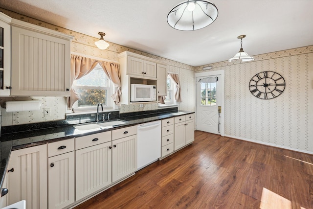 kitchen featuring dark hardwood / wood-style flooring, sink, decorative light fixtures, and white appliances