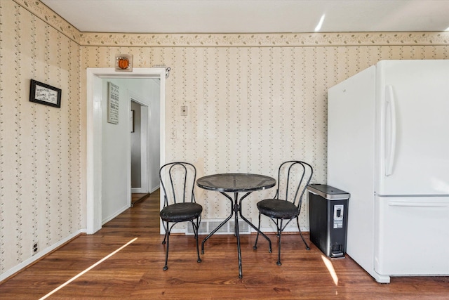 dining room with dark hardwood / wood-style flooring