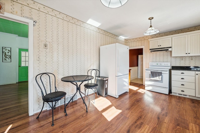 kitchen with white cabinets, white appliances, dark wood-type flooring, and hanging light fixtures