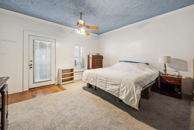 carpeted bedroom featuring ceiling fan and crown molding