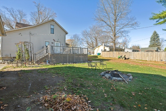 view of yard featuring an outdoor fire pit and a wooden deck