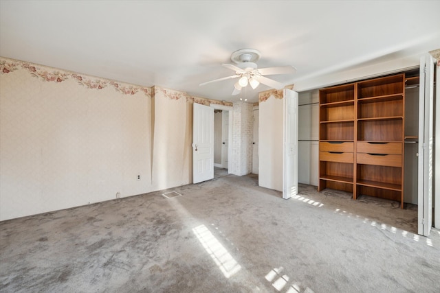 unfurnished bedroom with carpet floors and ceiling fan