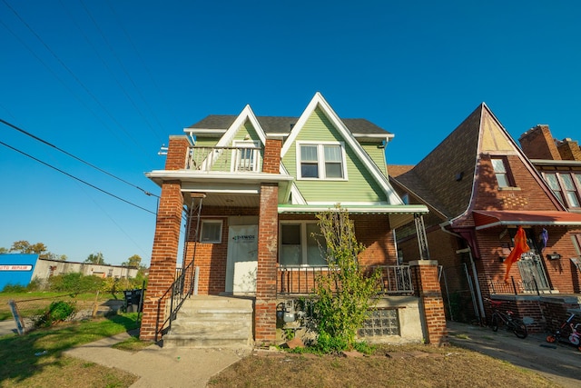 view of front of house featuring covered porch and a balcony