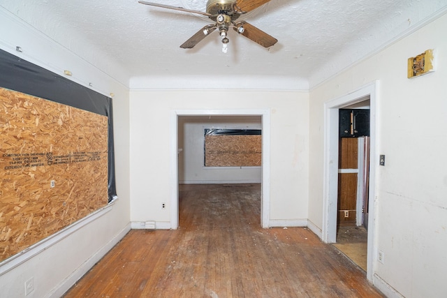 corridor featuring a textured ceiling and dark hardwood / wood-style flooring