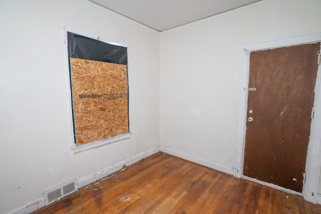 unfurnished room with dark hardwood / wood-style floors and ornamental molding