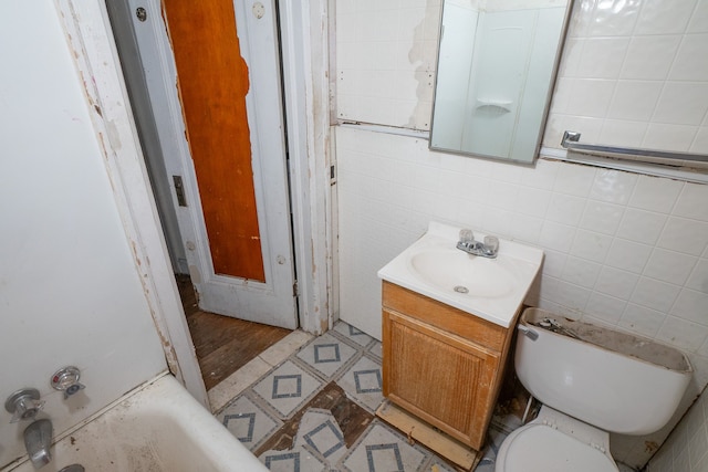 bathroom with vanity, wood-type flooring, tile walls, toilet, and a bathing tub