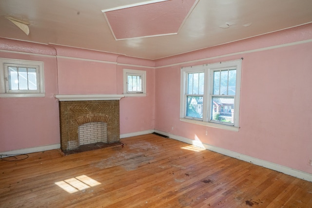 unfurnished living room featuring hardwood / wood-style floors and a healthy amount of sunlight