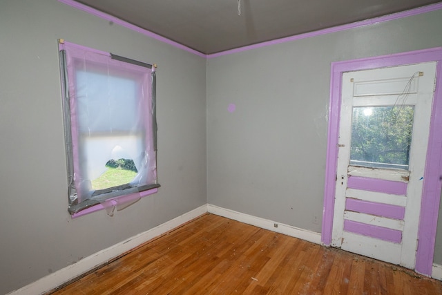 spare room with hardwood / wood-style flooring and ornamental molding