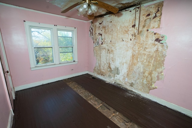 spare room with ceiling fan and dark wood-type flooring