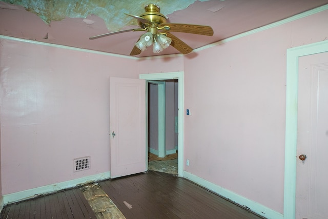 spare room with crown molding, ceiling fan, and dark wood-type flooring