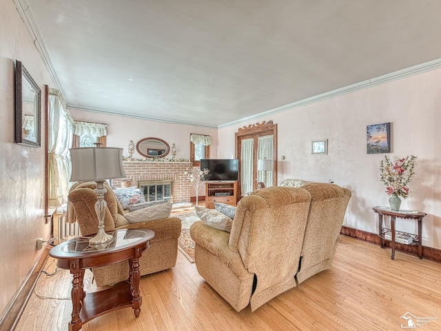 living room with a fireplace, light wood-type flooring, and ornamental molding