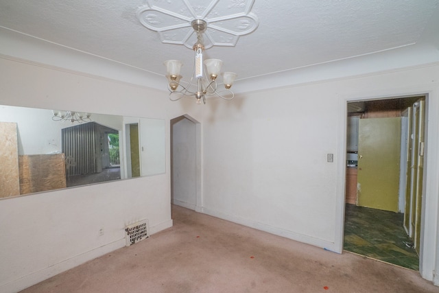 unfurnished dining area with a chandelier, a textured ceiling, and carpet floors