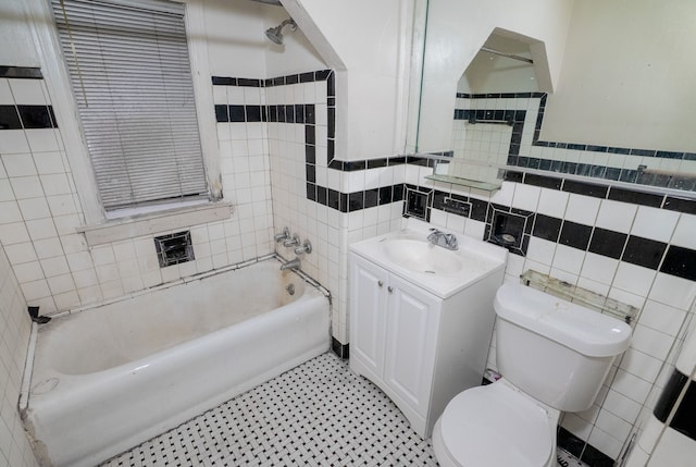 full bathroom with shower / bathing tub combination, vanity, toilet, and tile walls