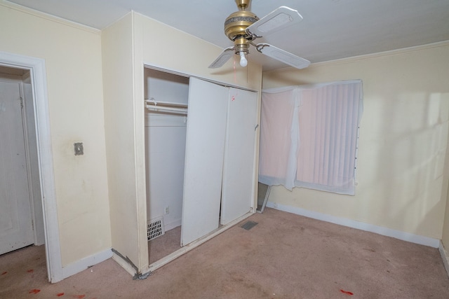 unfurnished bedroom featuring light carpet, a closet, ceiling fan, and ornamental molding