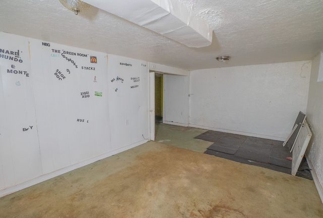 interior space featuring concrete flooring and a textured ceiling