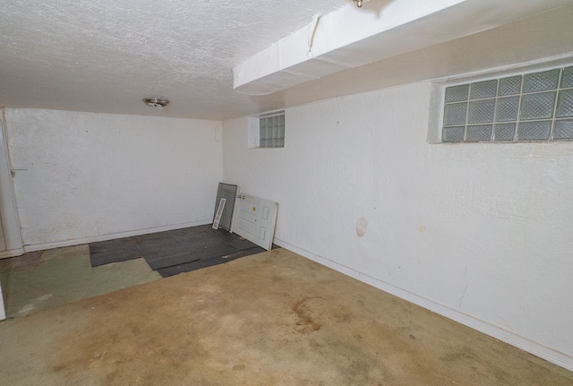 basement featuring a textured ceiling