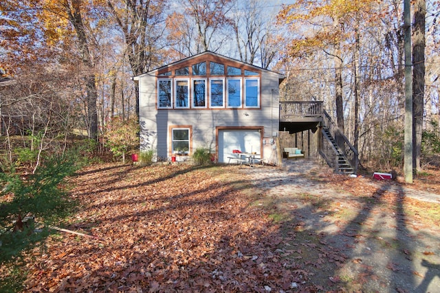 view of front of house with a garage and a deck