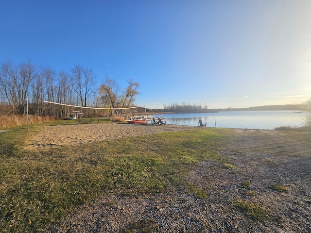 view of yard featuring volleyball court and a water view