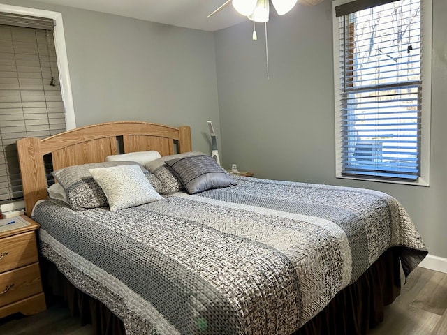 bedroom with baseboards and wood finished floors