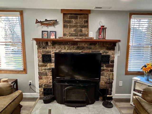 interior details featuring visible vents, baseboards, and wood finished floors