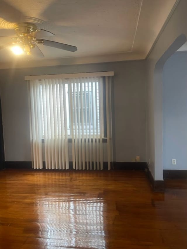 spare room with hardwood / wood-style floors and ceiling fan