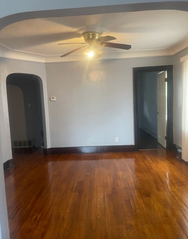 empty room featuring a textured ceiling, dark hardwood / wood-style floors, and ceiling fan