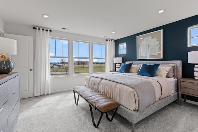 bedroom featuring light carpet, visible vents, and recessed lighting