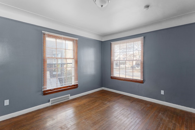 unfurnished room featuring dark hardwood / wood-style flooring and plenty of natural light